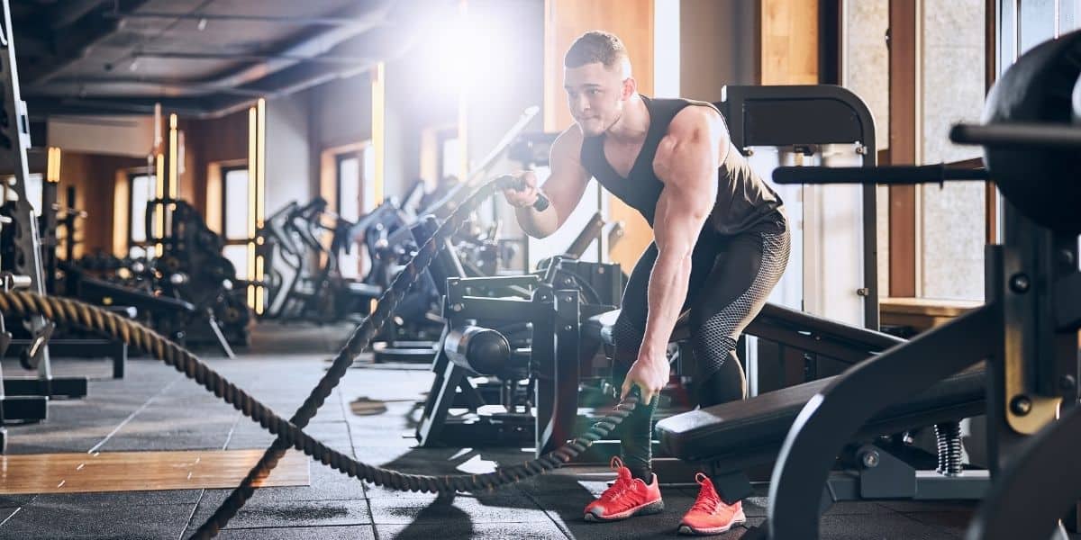 Man using rope to workout at a gym