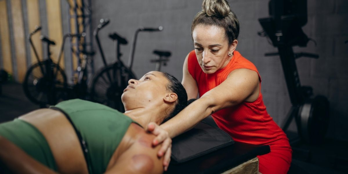 woman stretching a womans shoulder