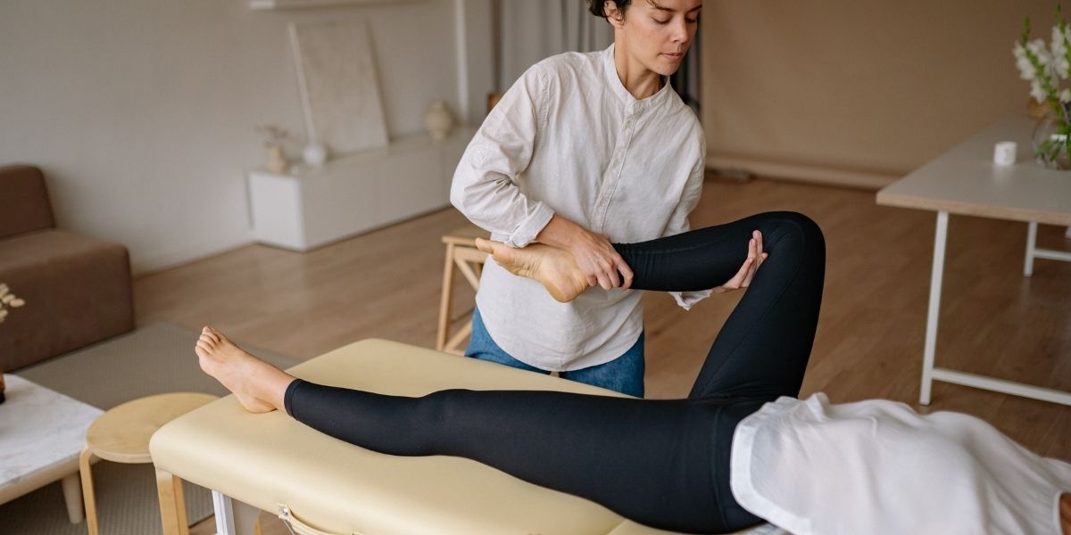 woman stretching someones leg