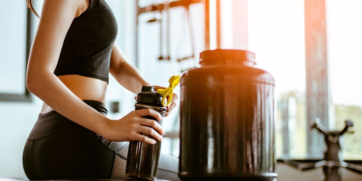 woman in the gym with protein powder